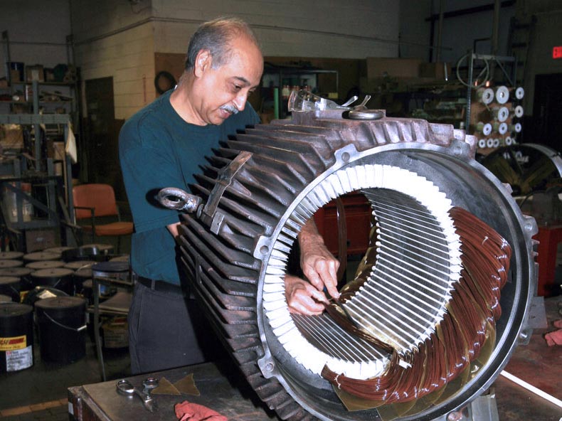 Man working on silver electric motor